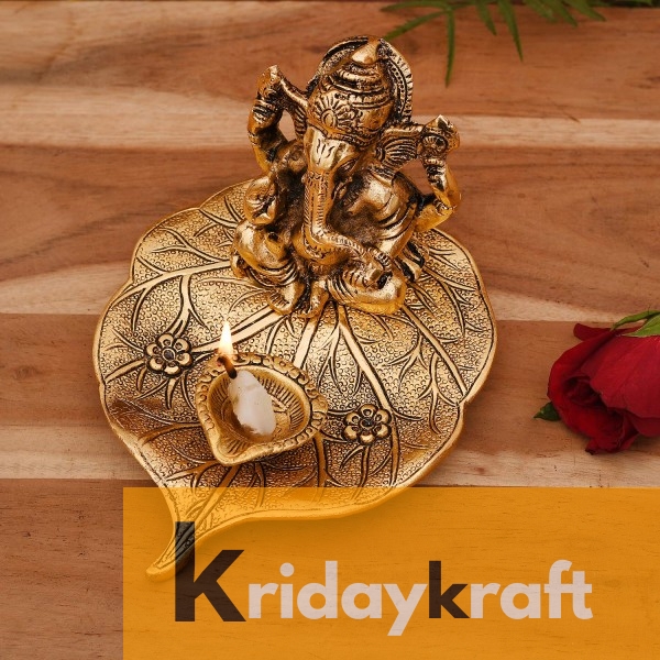 Ganesha sitting on leaf with oil lamp diya xl size gold plated for home decor and gifts