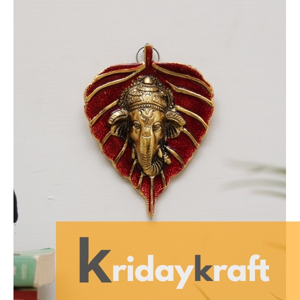 wall hanging ganesha face with red leaf gold plated metal 